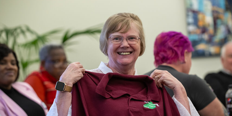 An RCN member holding up a shirt from her local branch