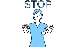 A health care worker holding hands in front of them while saying stop