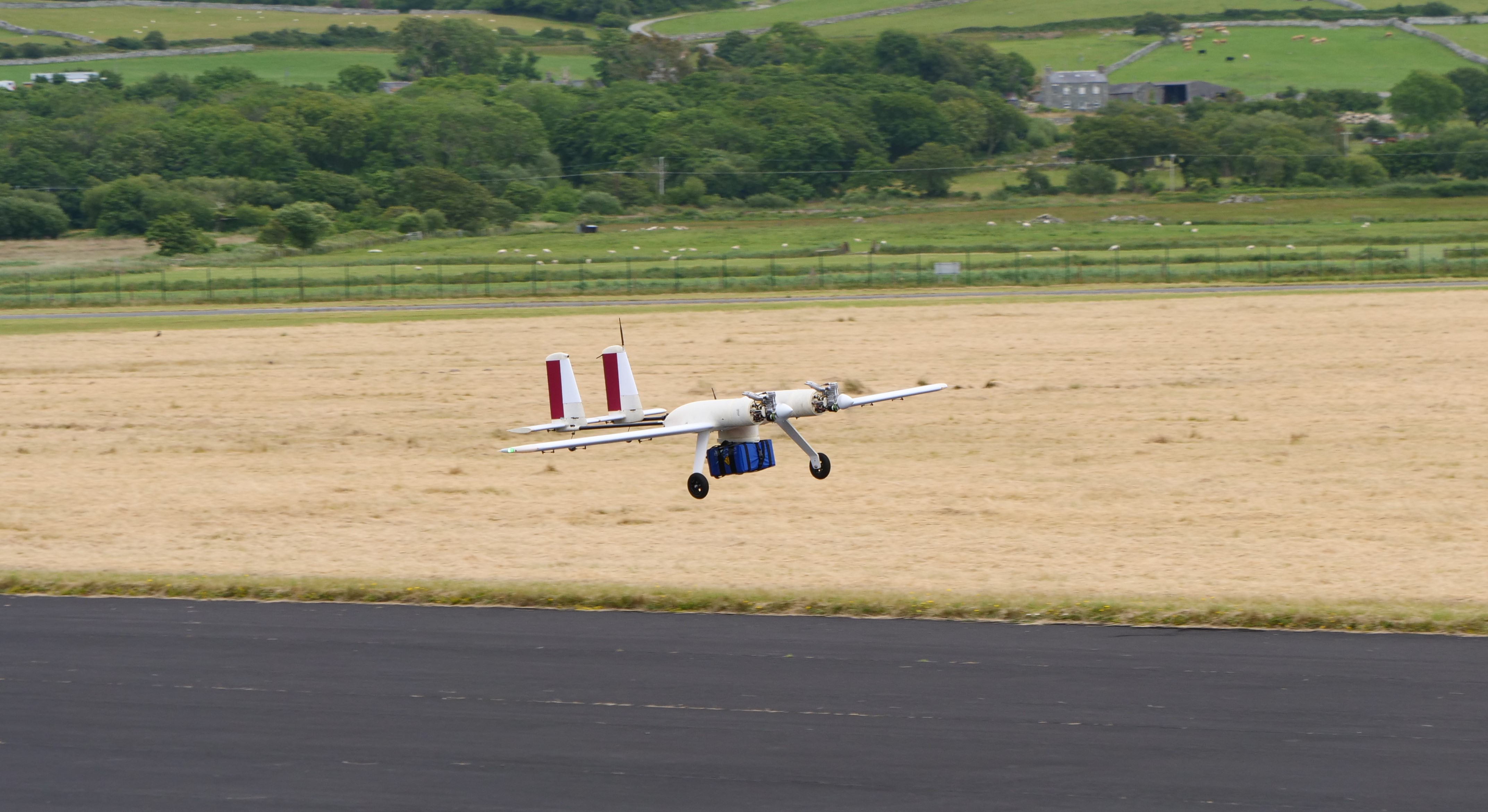 photo of a drone landing holding a package