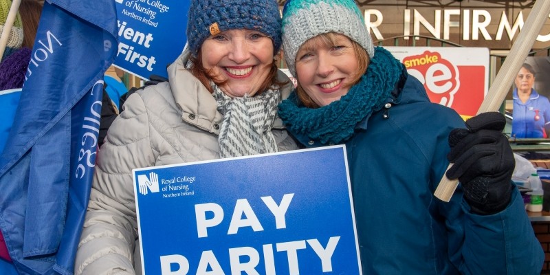 Nursing staff holding a pay parity sign