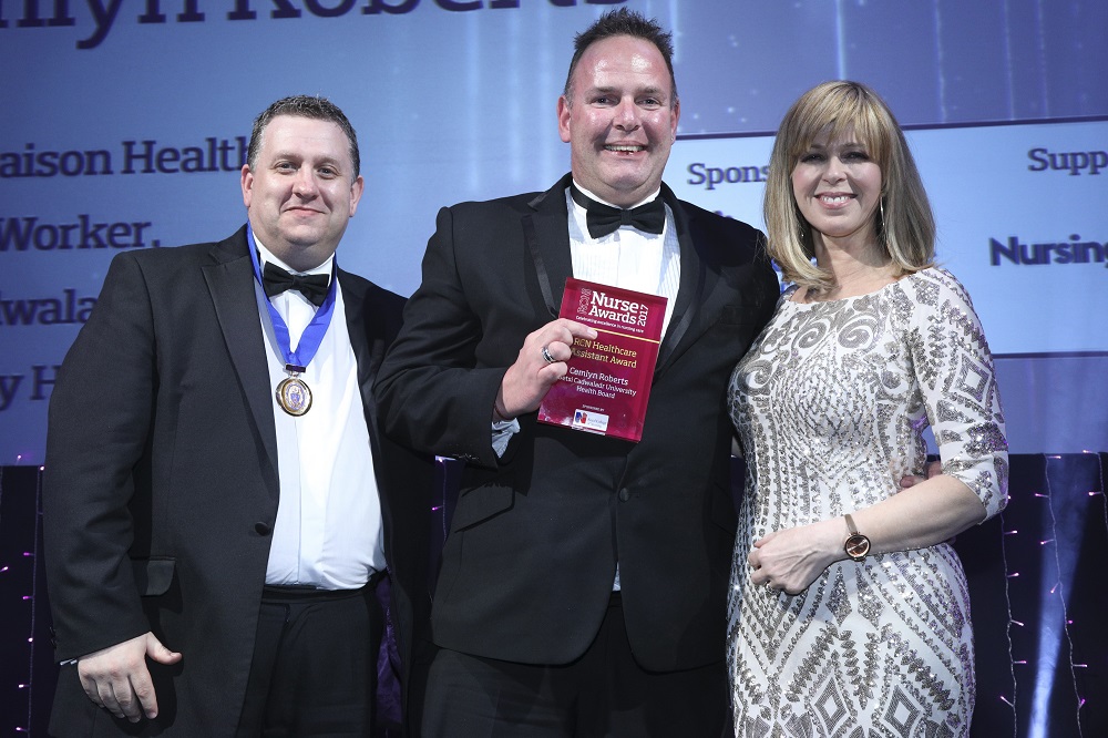 Cemlyn Roberts receives his award from Michael Brown and Kate Garraway